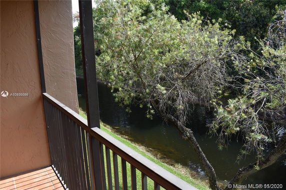 View from a balcony overlooking water and trees