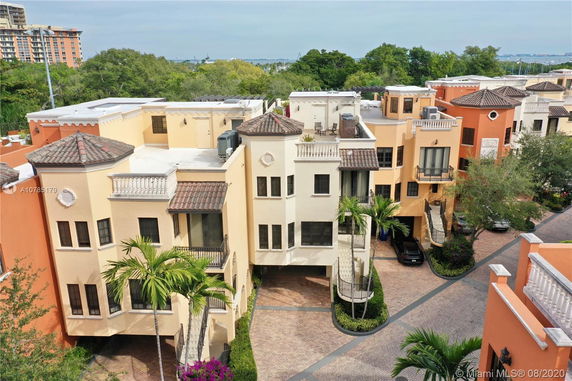 Elevated view of a Mediterranean-style residential complex with multiple floors and tiled roofs.