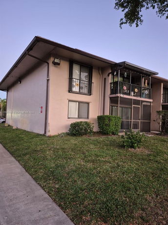 Front view of a two-story residential building with a balcony.
