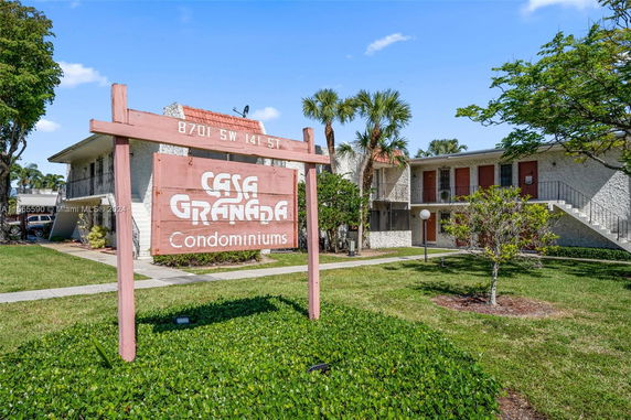 Front view of a condominium building with a sign reading 'Casa Granada Condominiums'.