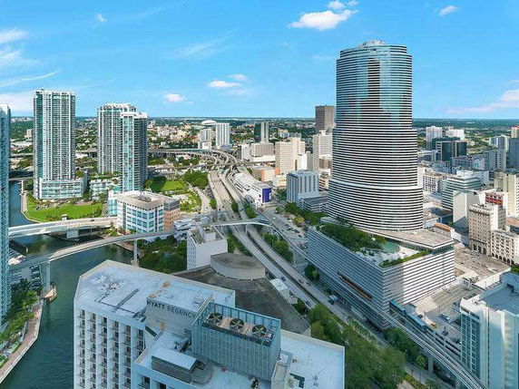 Panoramic view of a cityscape with high-rise buildings and a river.