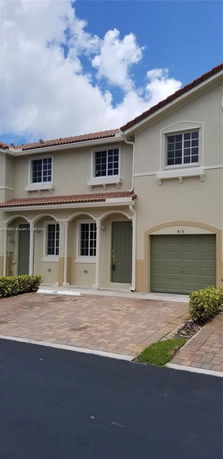 Front view of a two-story house with a single garage.