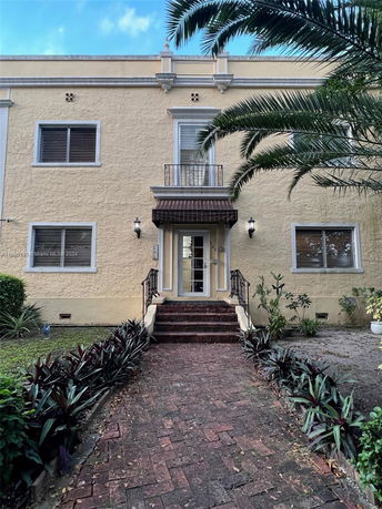 Front view of a two-story house with a central entrance and staircase.