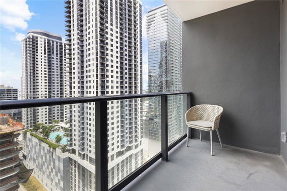 View from a balcony overlooking high-rise buildings.