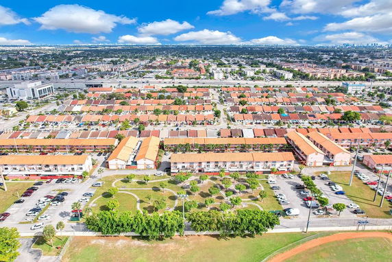 Panoramic view of a residential area with multiple buildings and parking lots.