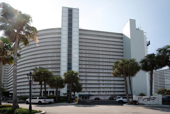 Front view of a tall multi-story building with curved facade.