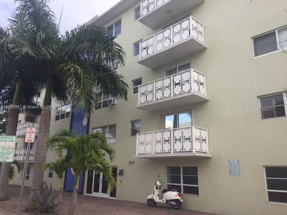 Front view of a multi-story residential building with balconies.