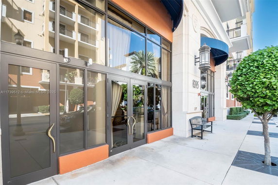 Front view of a modern commercial building with large glass windows and decorative awnings.