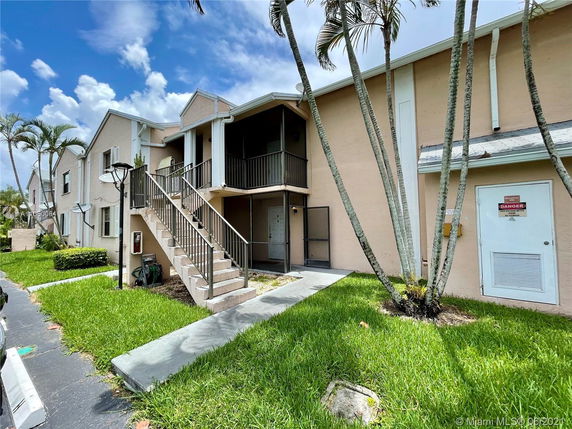 Front view of a two-story residential building with exterior staircases.