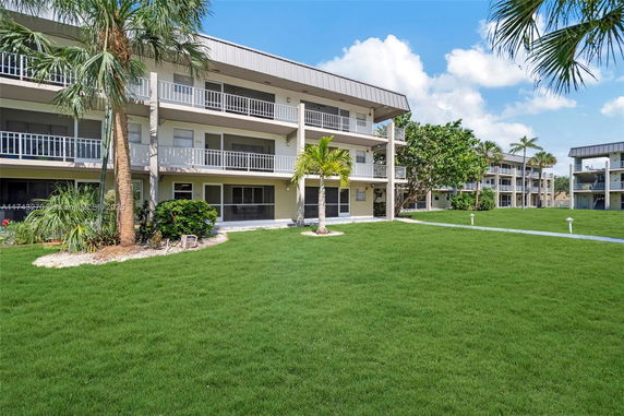 Front view of a three-story residential building with balconies.