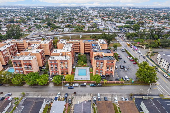 Aerial view of an apartment complex with a central swimming pool and extensive surrounding area.