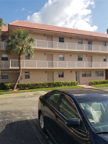 Front view of a multi-story residential building with balconies.