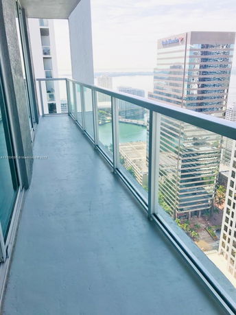 View from a balcony showing high-rise buildings in a cityscape.