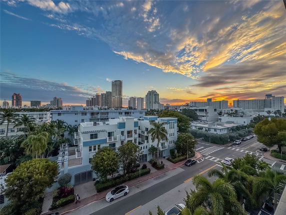Panoramic view of city buildings at sunset.
