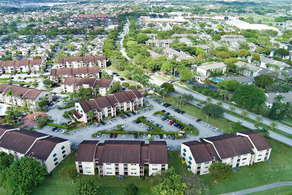 Aerial view of a residential area with multiple apartment buildings and parking lots.