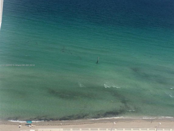 Panoramic view of a beach and ocean from a high vantage point.