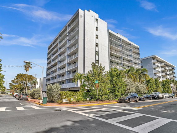 Front view of a multi-story apartment building with balconies.