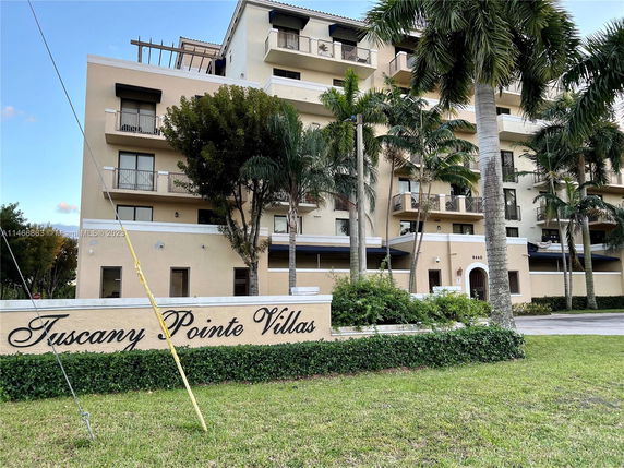 Front view of a multi-story residential building named Tuscany Pointe Villas.