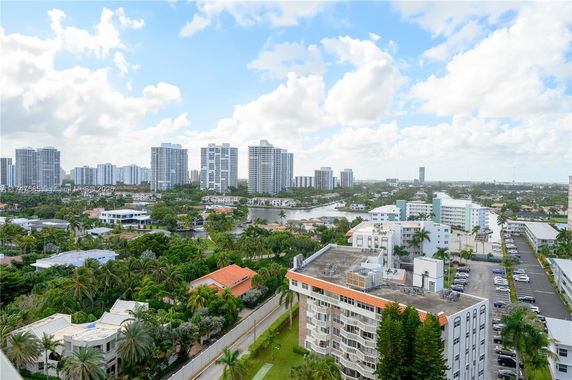 Panoramic view of a cityscape with multiple high-rise buildings and greenery.