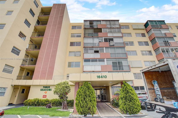 Front view of a multi-story residential building with balconies.