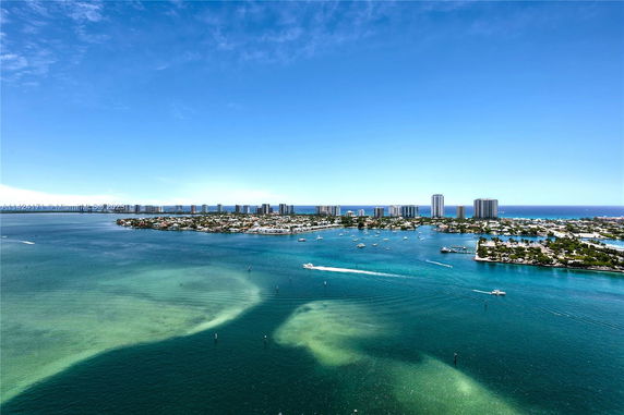 Wide angle view of a coastline with buildings and waterways.