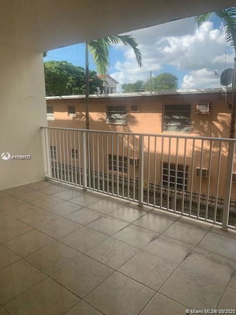 View from a balcony showing neighboring building and sky.