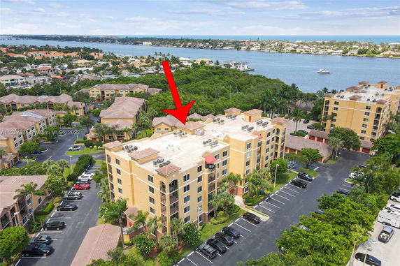 Rooftop of a multi-story apartment building with air conditioning units.