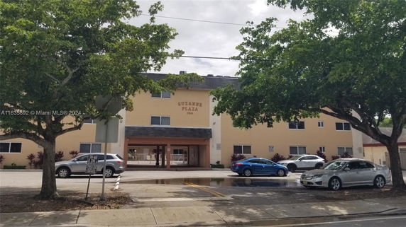 Front view of a multi-story building named Suzanne Plaza.
