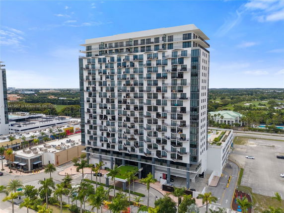 Front view of a modern high-rise building with multiple balconies.