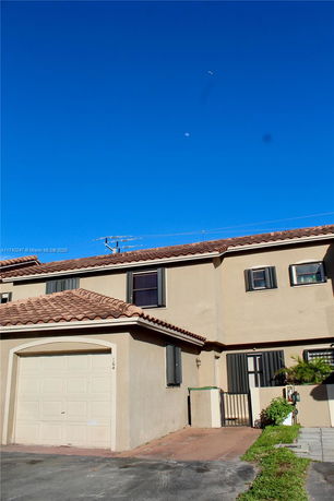 Front view of a two-story house with a garage.