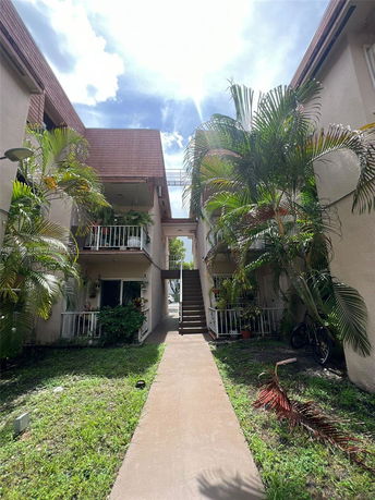 View of apartment buildings with balconies and exterior stairs.