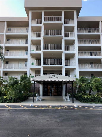 Front view of a multi-story building with balconies and an entrance canopy labeled 'Fourteen'.