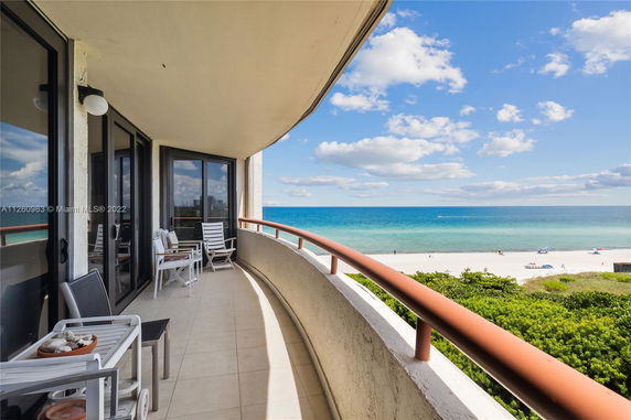 Balcony view overlooking the ocean and beach.