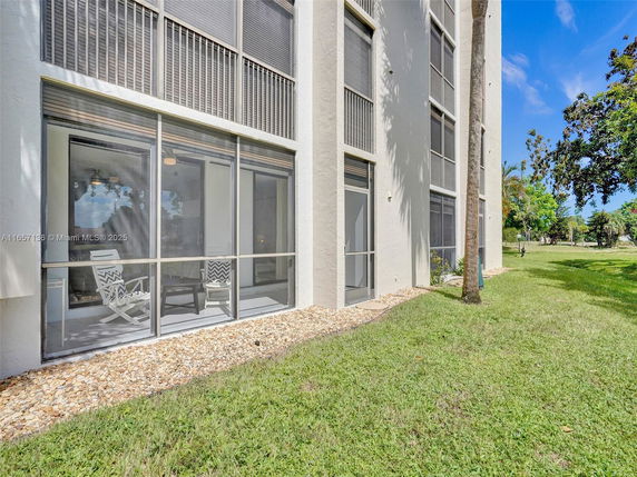 Partial elevation view of a multi-story building with screened-in patios and vertical windows.