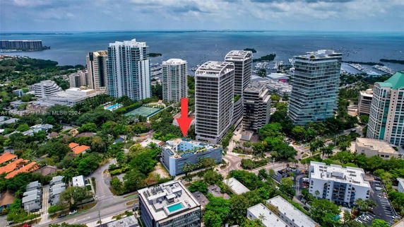 Elevated view of a coastal urban area with multiple high-rise buildings and a marina.