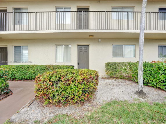 Front view of a two-story apartment building with balconies.