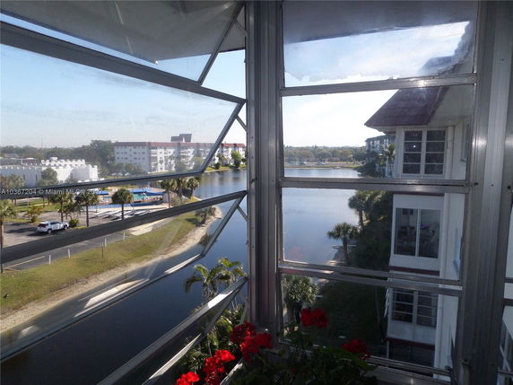View from a window showing multiple apartment buildings and a waterway.