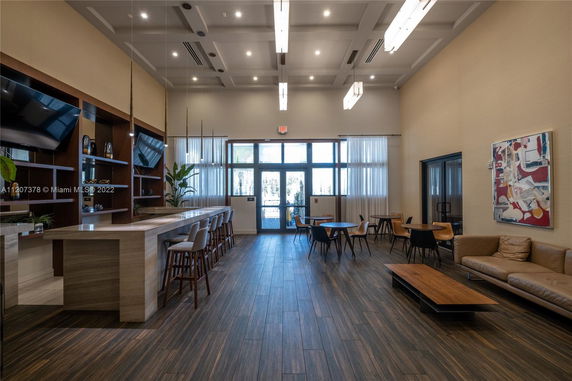 Indoor recreation area with bar seating, tables, and a lounge area.