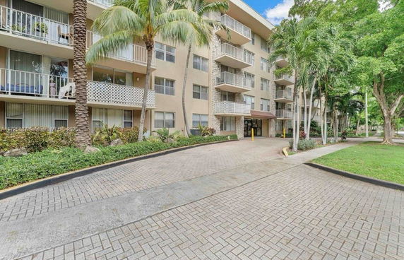 Front view of a multi-story apartment building with balconies.