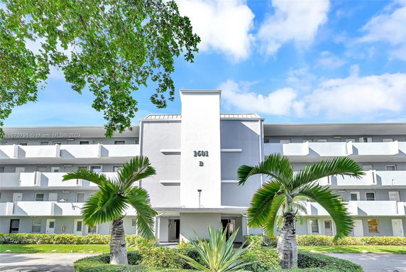 Front view of a multi-story residential building with balconies.