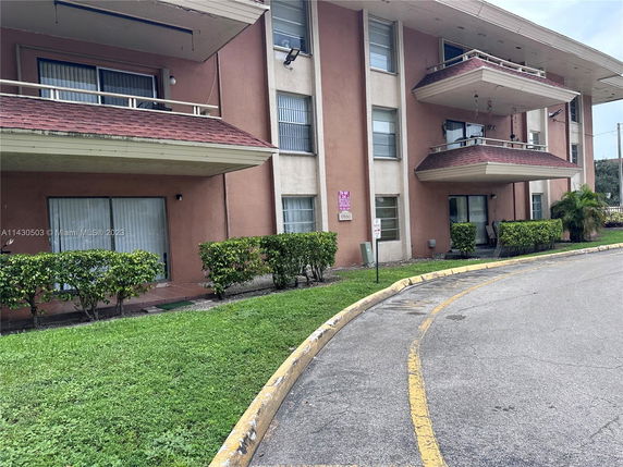Front view of a multi-story residential building with balconies.