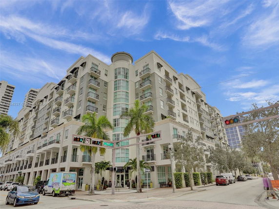 Front view of a multi-story residential building with balconies.