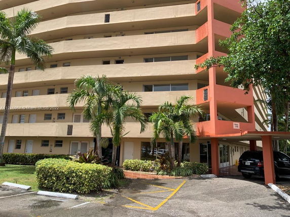 Front view of a multi-story residential building with balconies.