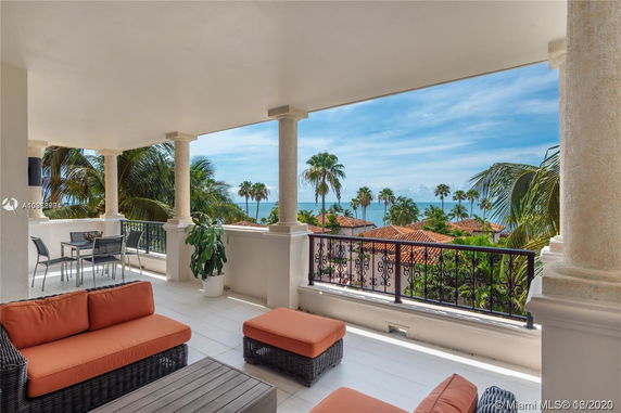 Balcony with outdoor seating and ocean view.