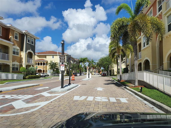 Street view of a residential area with multi-story buildings.