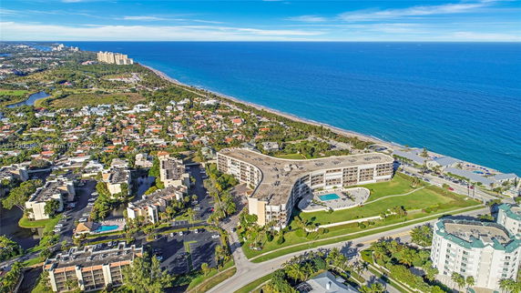 Panoramic aerial view of coastal buildings and ocean.