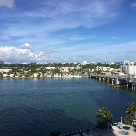 Panoramic view of waterway and distant cityscape.