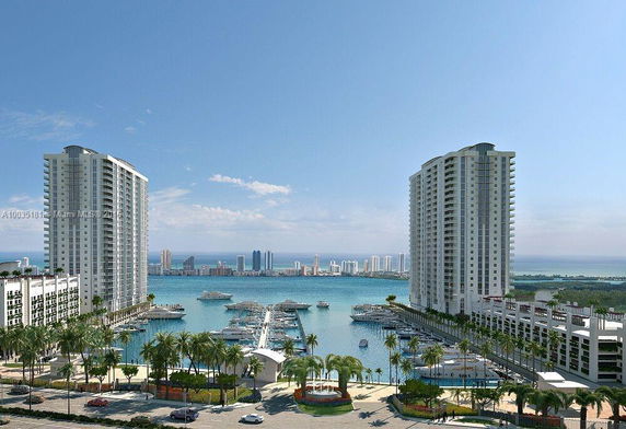 View of high-rise buildings overlooking a marina and waterfront area.