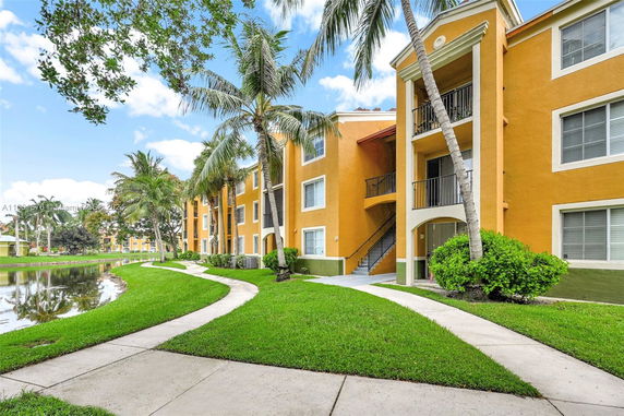 Front view of a three-story apartment building with balconies.