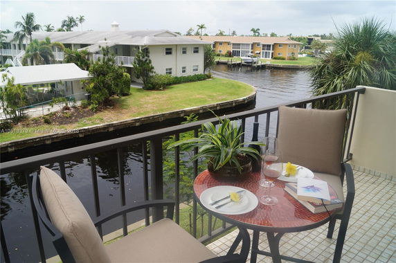 View from a balcony overlooking a canal and nearby residential buildings.